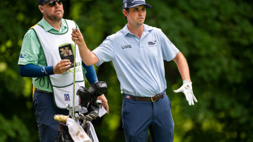 J.T. Poston grabs a club in the third round of the John Deere Classic