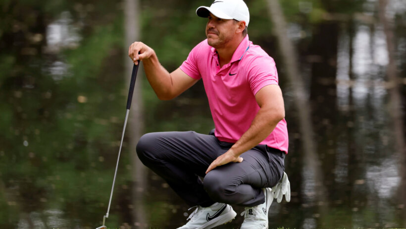 Brooks Koepka wincing on the green