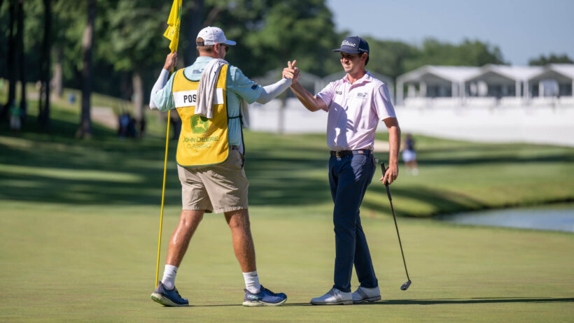 J.T. Poston shakes hands with his caddie after a round