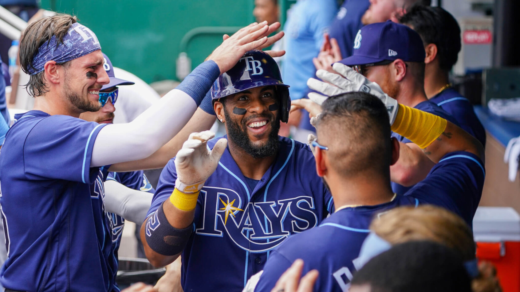 Tampa Bay Rays players celebrating in the dugout.