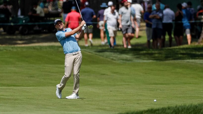 Russell Henley hitting a shot from the fairway
