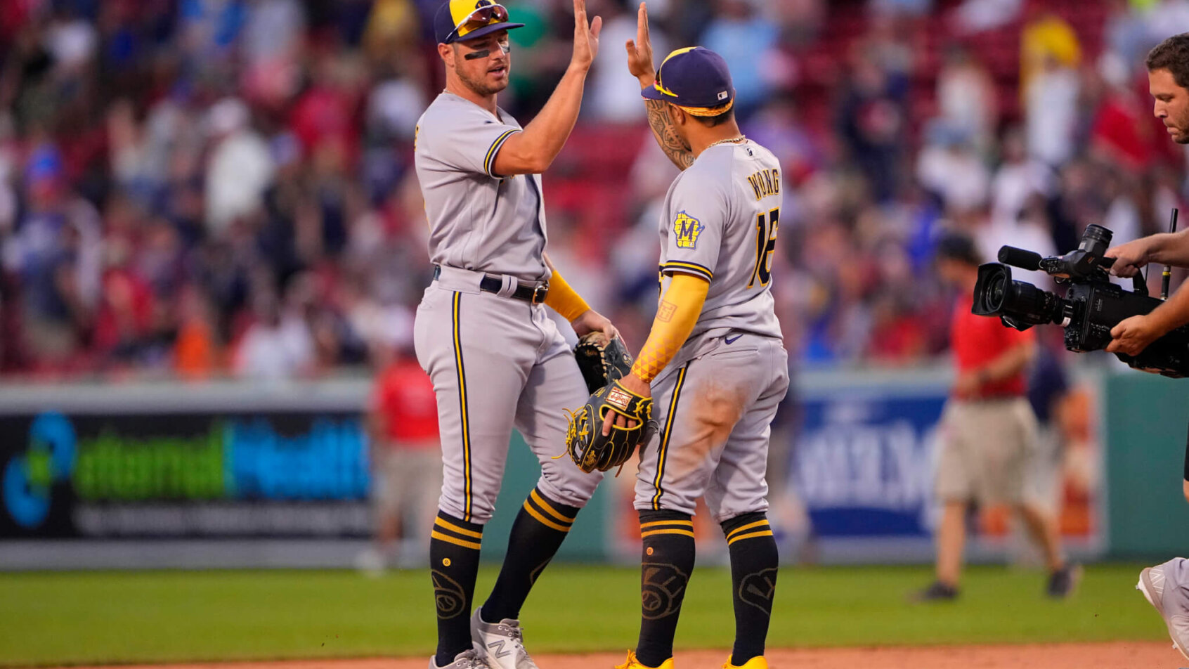 Milwaukee Brewers right fielder Hunter Renfroe high-fiving second baseman Kolten Wong