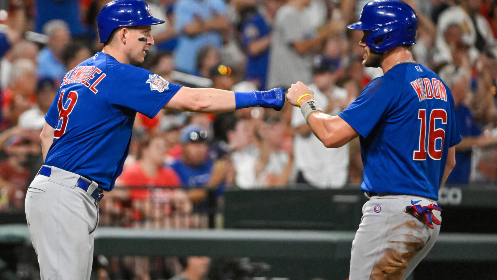 Patrick Wisdom and Frank Schwindel celebrating at home plate