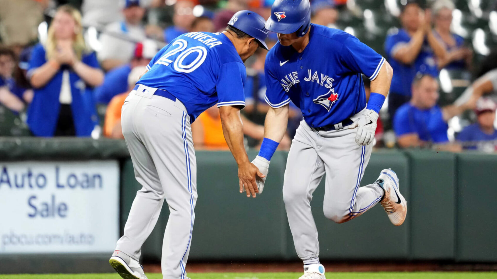 Toronto Blue Jays third baseman Matt Chapman celebrates with third-base coach Luis Rivera after hitting a home run