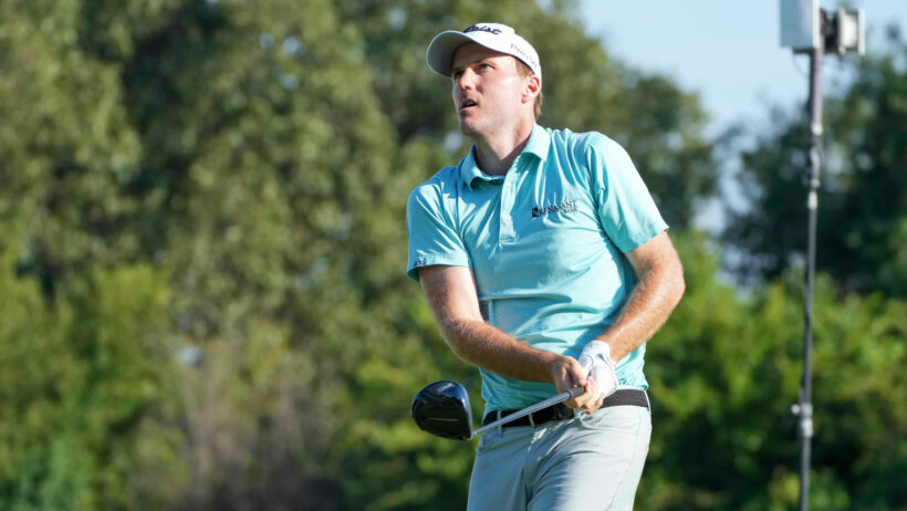 Russell Henley watching his tee shot