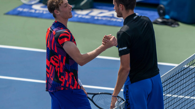 Daniil Medvedev at the net with Denis Shapovalov