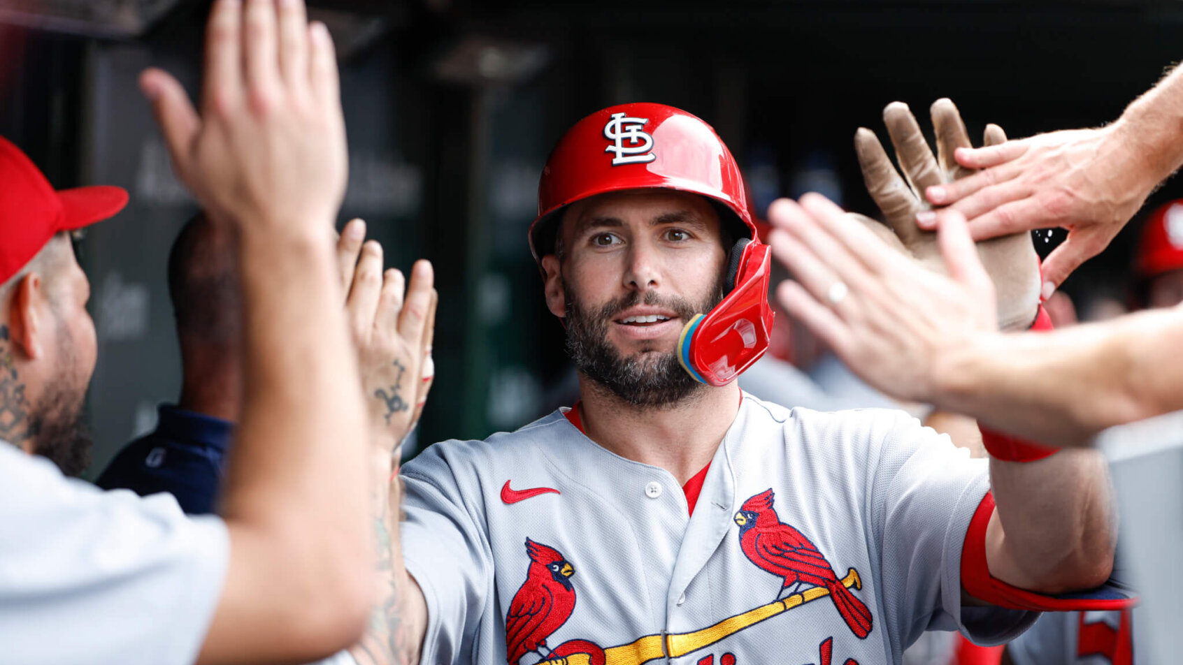 Paul Goldschmidt hi-fiving teammates in dugout