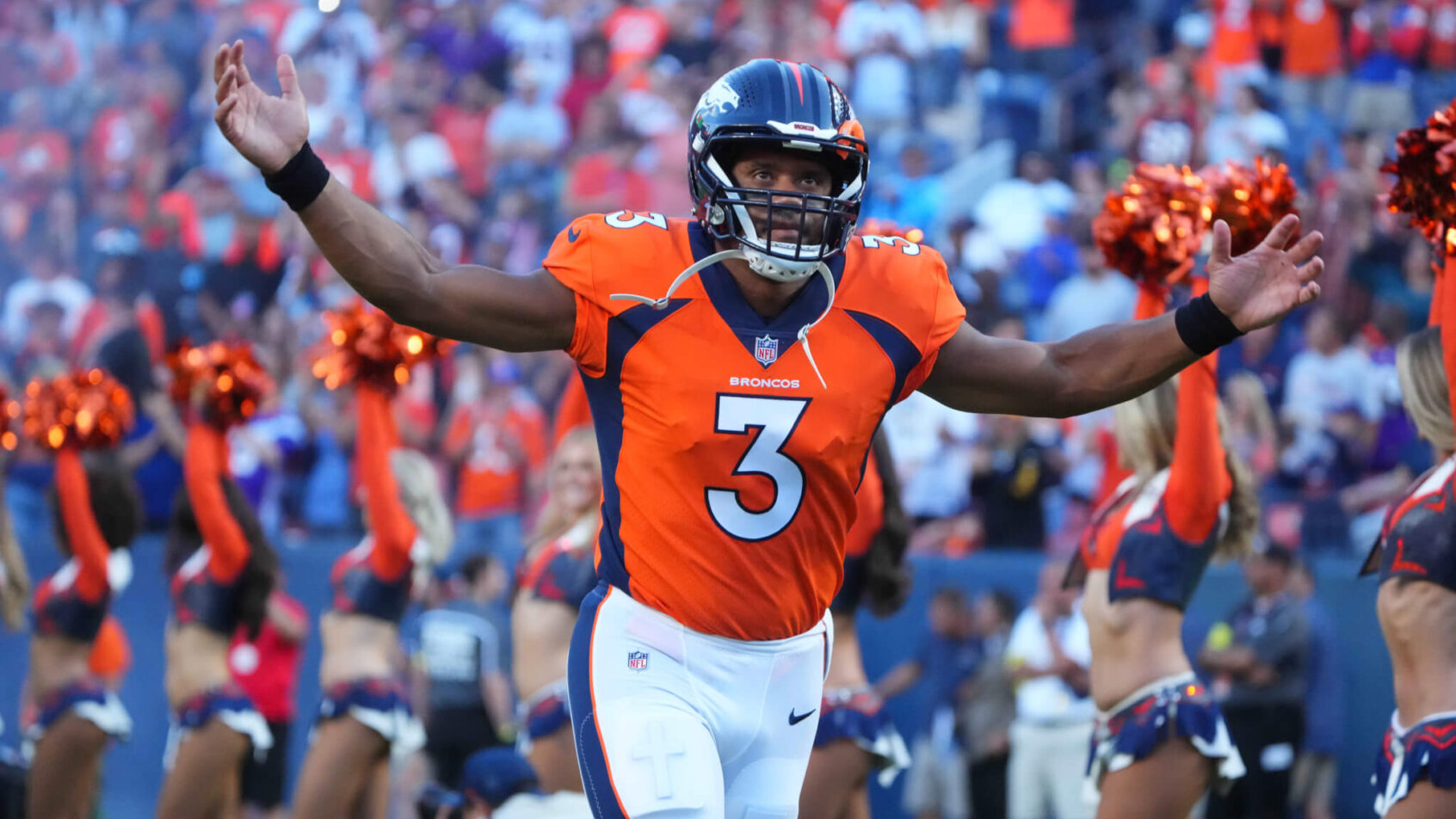 Denver Broncos quarterback Russell Wilson throws arms in the air