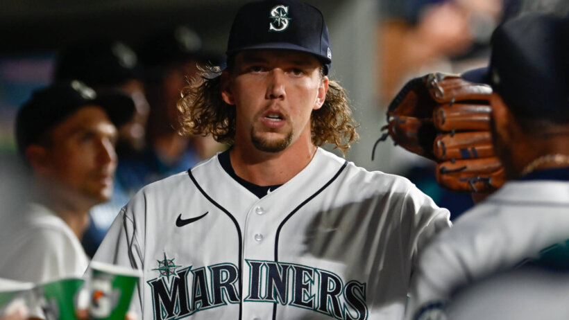 Seattle Mariners starting pitcher Logan Gilbert high-fiving teammates in the dugout