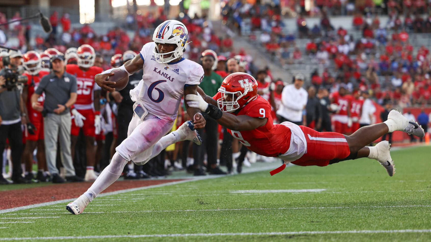 Kansas Jayhawks quarterback Jalon Daniels runs with the ball to score a touchdown