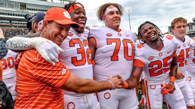 Clemson head coach Dabo Swinney, defensive tackle Etinosa Reuben, offensive lineman Tristan Leigh, and safety Jalyn Phillips