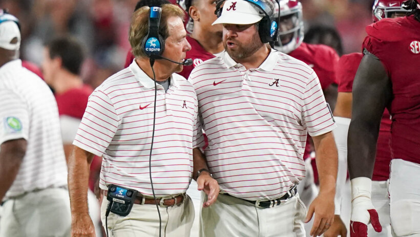 Alabama Crimson Tide head coach Nick Saban and defensive coordinator Pete Golding talking on the sideline