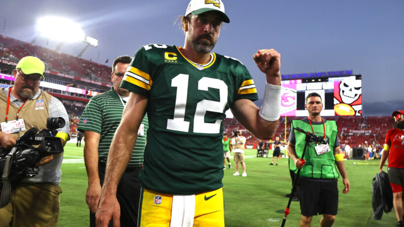 Green Bay Packers quarterback Aaron Rodgers walking off the field after a win