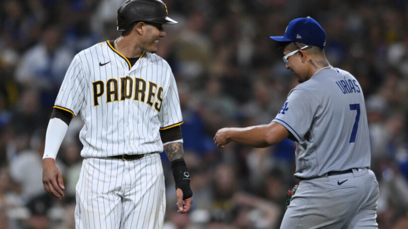 San Diego Padres third baseman Manny Machado talking to Los Angeles Dodgers starting pitcher Julio Urias on the field
