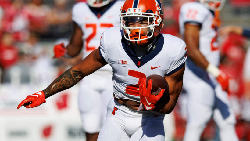 Illinois Fighting Illini running back Chase Brown carries the football