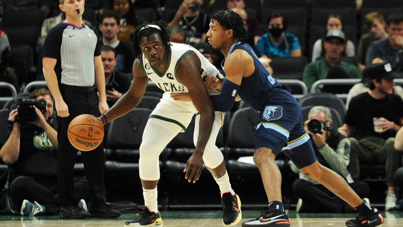 Milwaukee Bucks guard Jrue Holiday backing down Memphis Grizzlies guard Kennedy Chandler