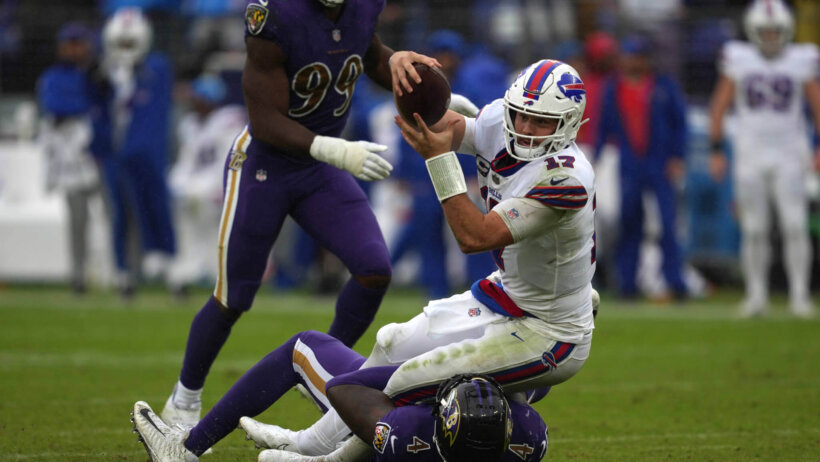 Buffalo Bills quarterback Josh Allen running with the ball against the Baltimore Ravens