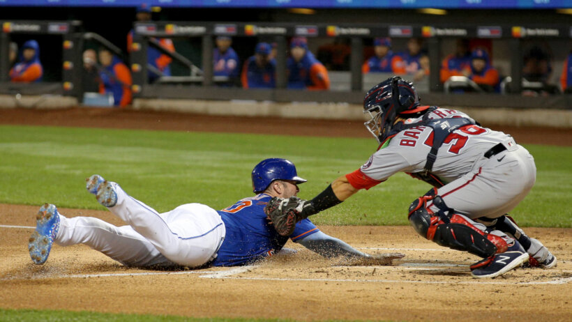 New York Mets first baseman Pete Alonso sliding into home