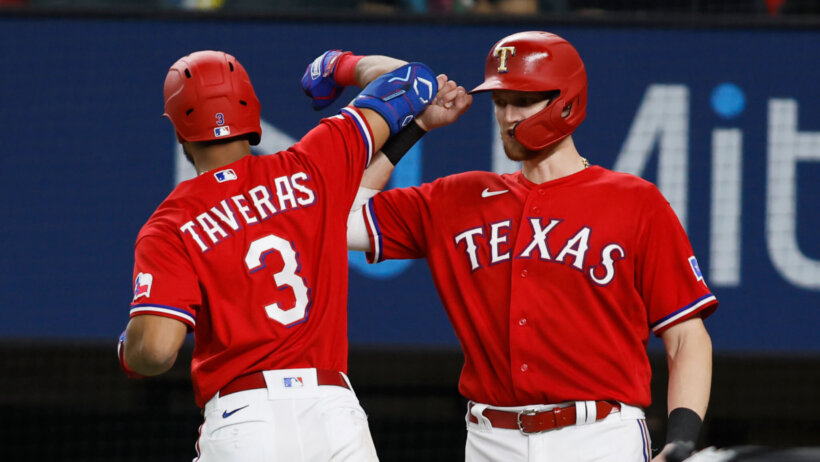 Texas Rangers center fielder Leody Taveras celebrates a home run with catcher Sam Huff