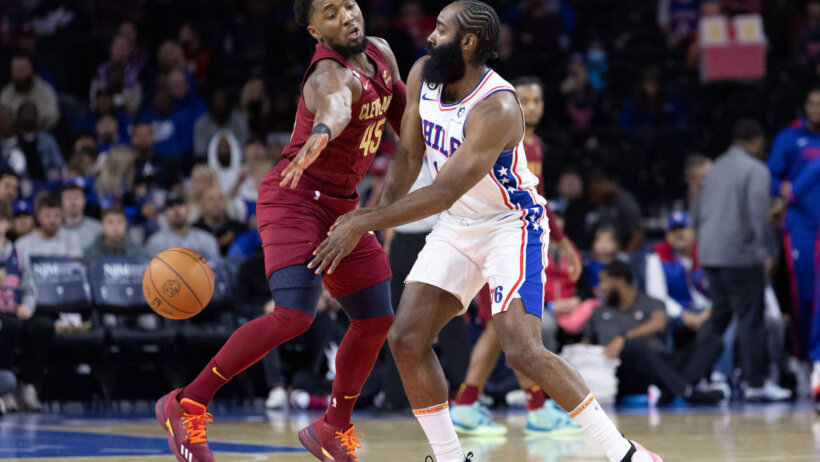Philadelphia 76ers guard James Harden battles for the ball with Cleveland Cavaliers guard Donovan Mitchell