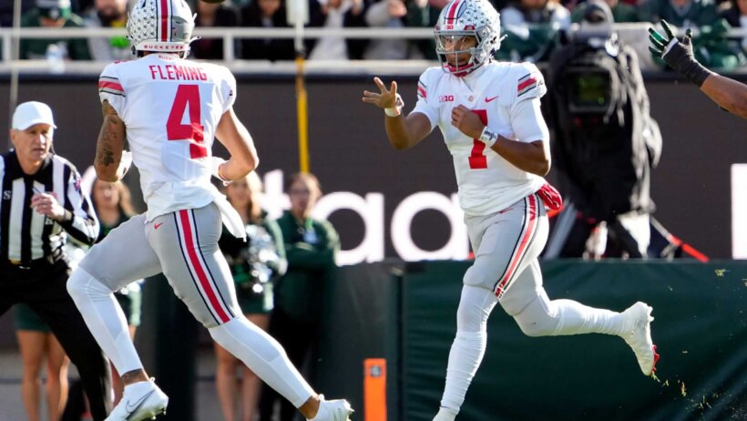 Ohio State Buckeyes quarterback C.J. Stroud throws the ball to wide receiver Julian Fleming