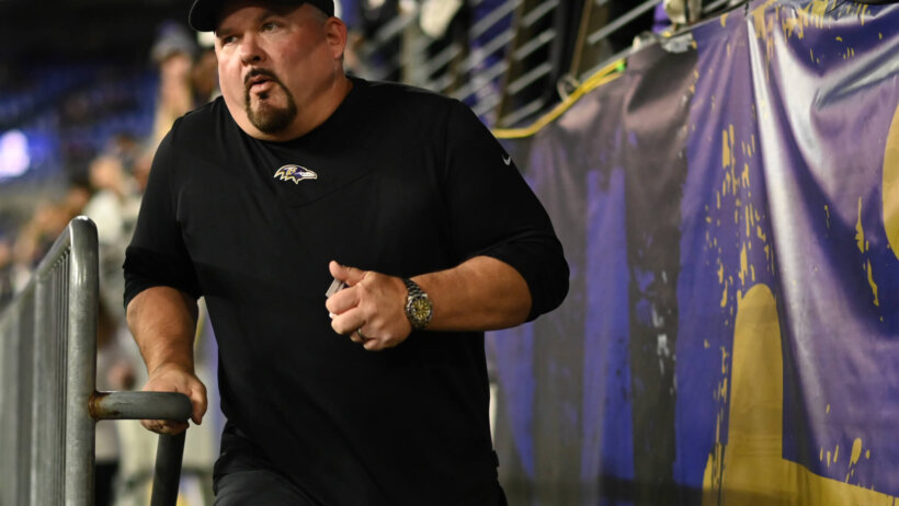 Baltimore Ravens offensive coordinator Greg Roman runs on the field