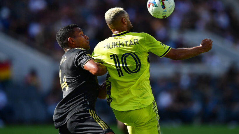Hany Mukhtar playing for a ball against Eddie Segura during a MLS match.