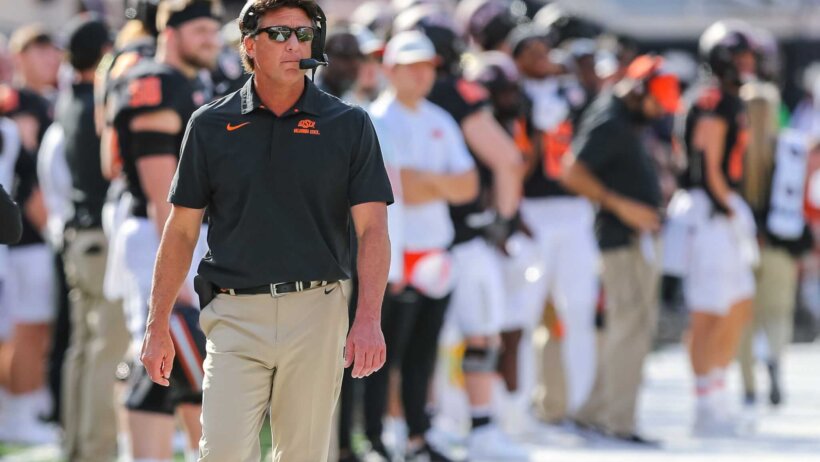 Oklahoma State head coach Mike Gundy walks the sidelines