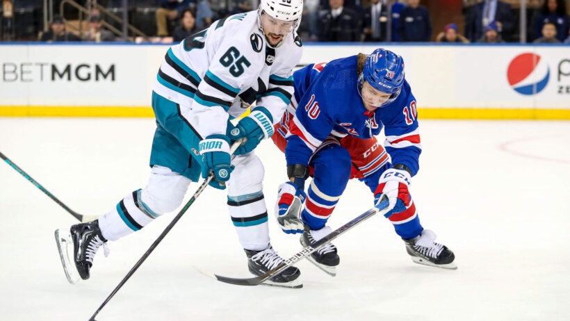 San Jose Sharks defenseman Erik Karlsson and New York Rangers left wing Artemi Panarin battle for the puck