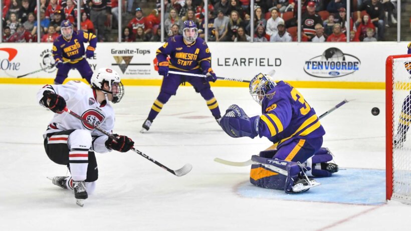 St. Cloud State's Grant Cruikshank gets the puck past Alex Tracy