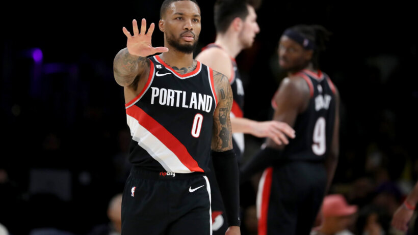 Portland Trail Blazers guard Damian Lillard signaling to his bench