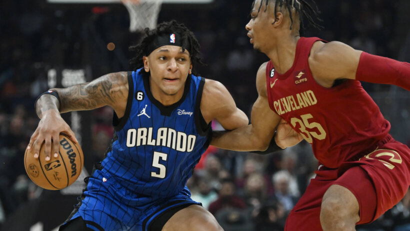 Orlando Magic forward Paolo Banchero drives to the basket against Cleveland Cavaliers forward Isaac Okoro