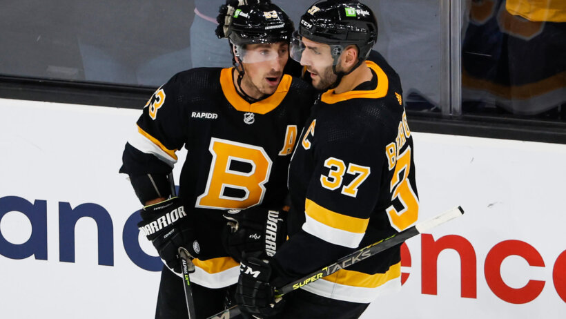 Boston Bruins center Patrice Bergeron congratulates left wing Brad Marchand