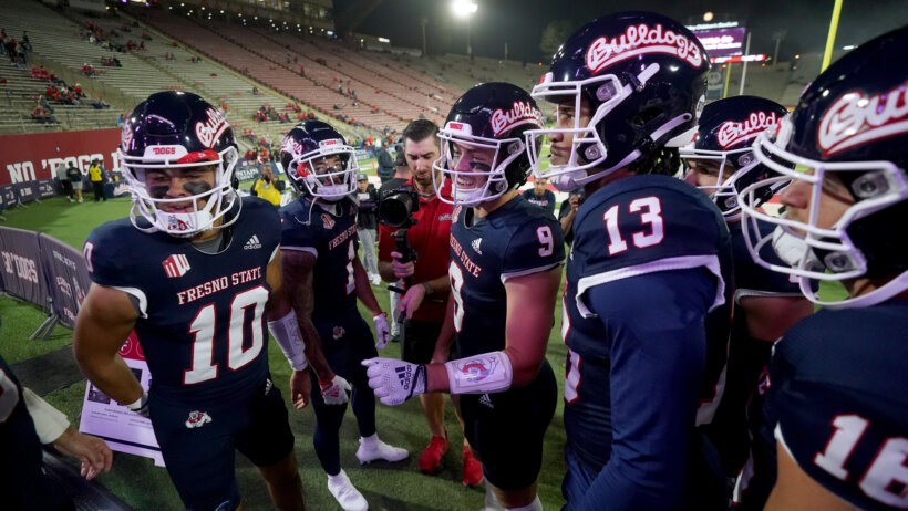 Fresno State Bulldogs quarterback Jake Haener meets with teammates