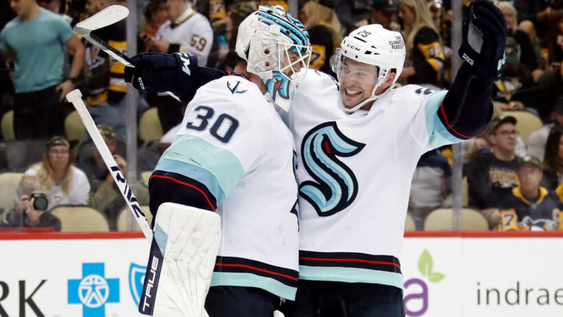 Seattle Kraken goaltender Martin Jones (30) and defenseman Vince Dunn celebrate