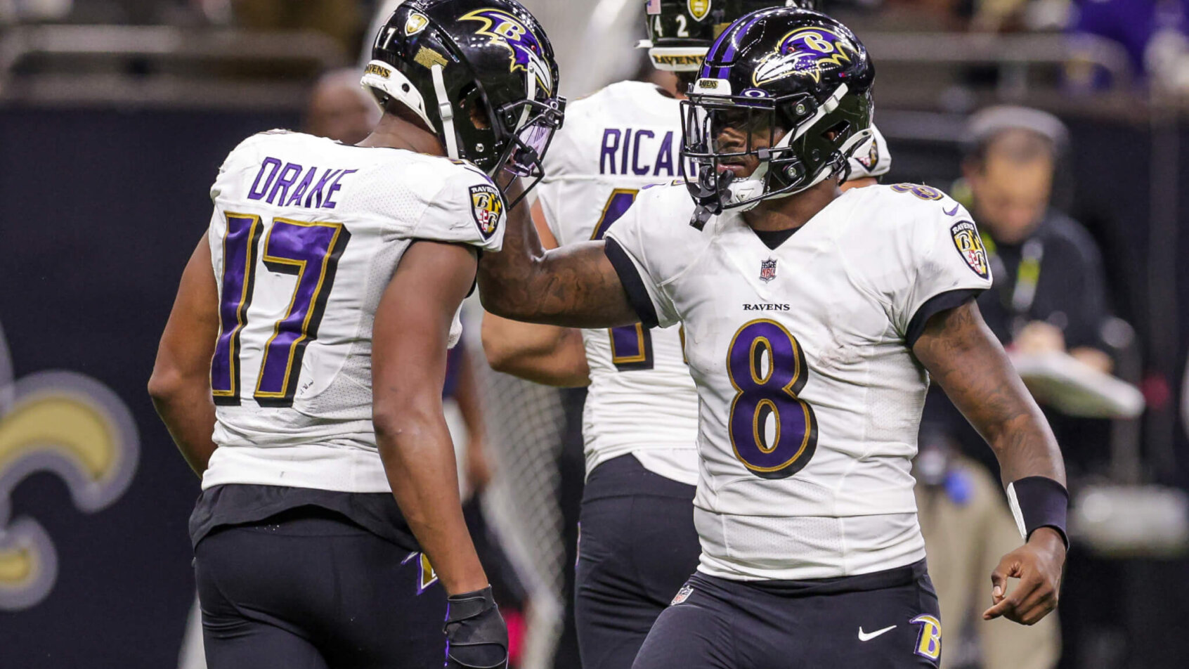 Baltimore Ravens quarterback Lamar Jackson congratulates running back Kenyan Drake