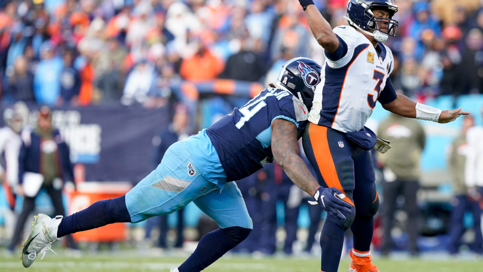 Denver Broncos quarterback Russell Wilson gets hit