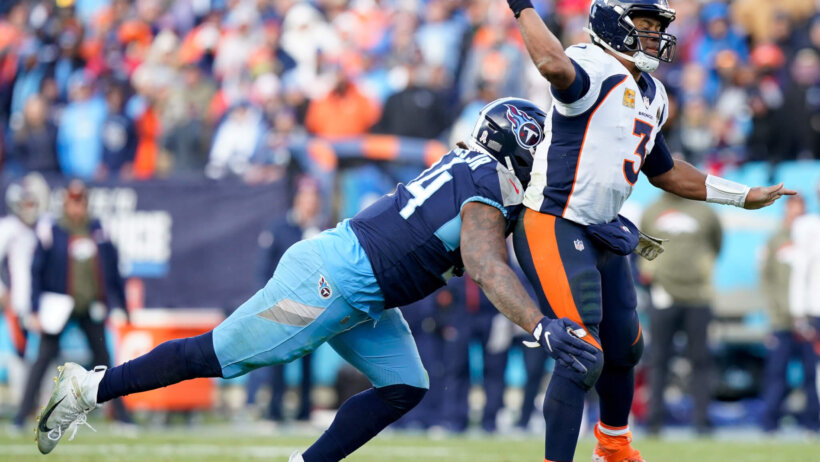 Denver Broncos quarterback Russell Wilson gets hit