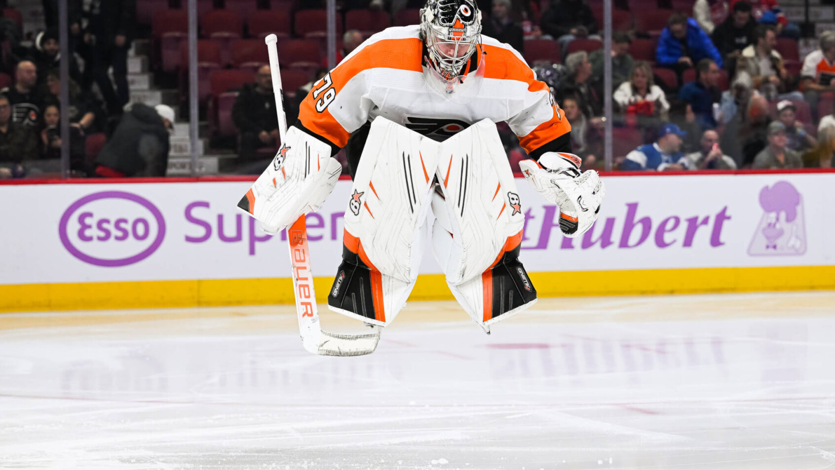 Philadelphia Flyers goalie Carter Hart jumps on the ice prior to the start of the second period