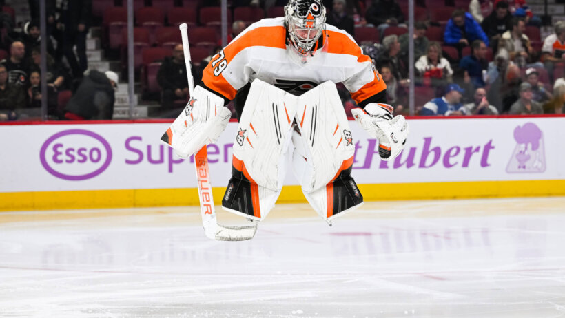 Philadelphia Flyers goalie Carter Hart jumps on the ice prior to the start of the second period