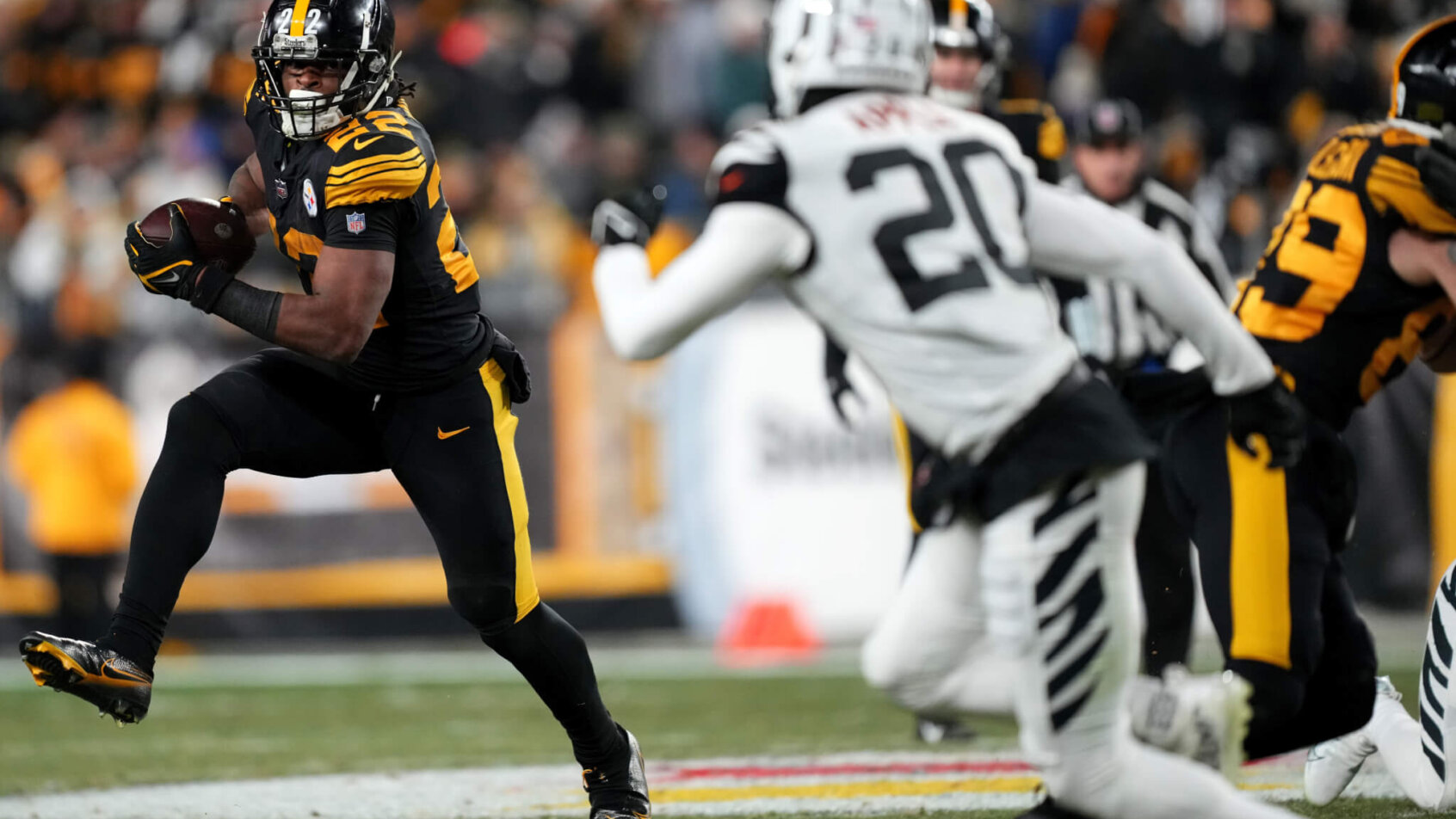 Najee Harris carries the football