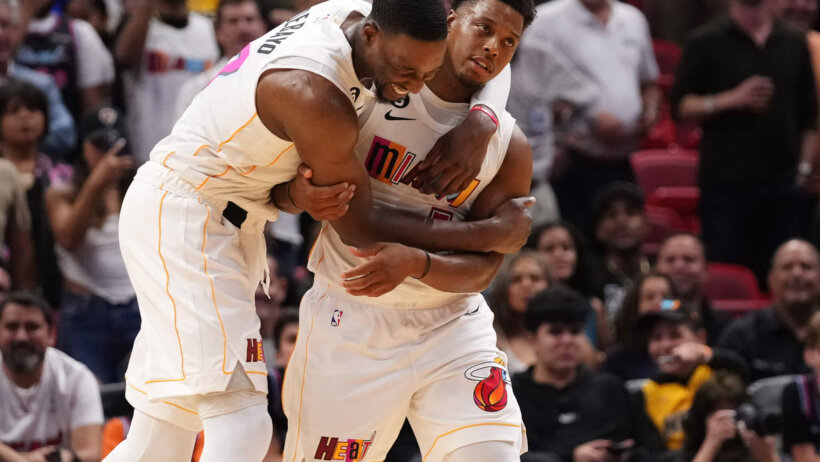 Miami Heat center Bam Adebayo hugging guard Kyle Lowry