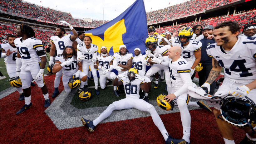 Michigan Wolverines players celebrate a win over Ohio State