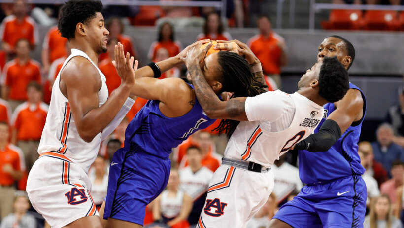 Saint Louis Billikens guard Yuri Collins battles for the ball with Alabama players