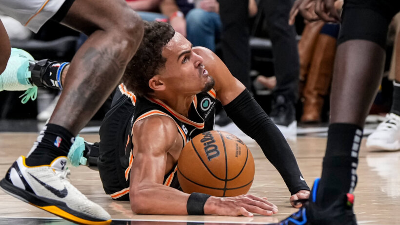 Atlanta Hawks guard Trae Young diving for a loose ball