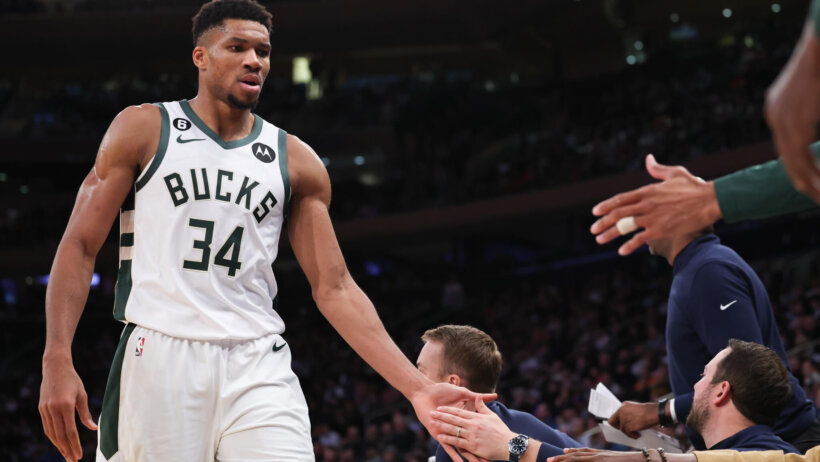 Milwaukee Bucks forward Giannis Antetokounmpo high-fiving teammates