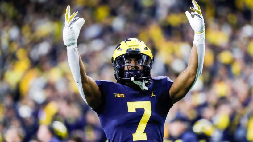 Michigan running back Donovan Edwards waves at the crowd