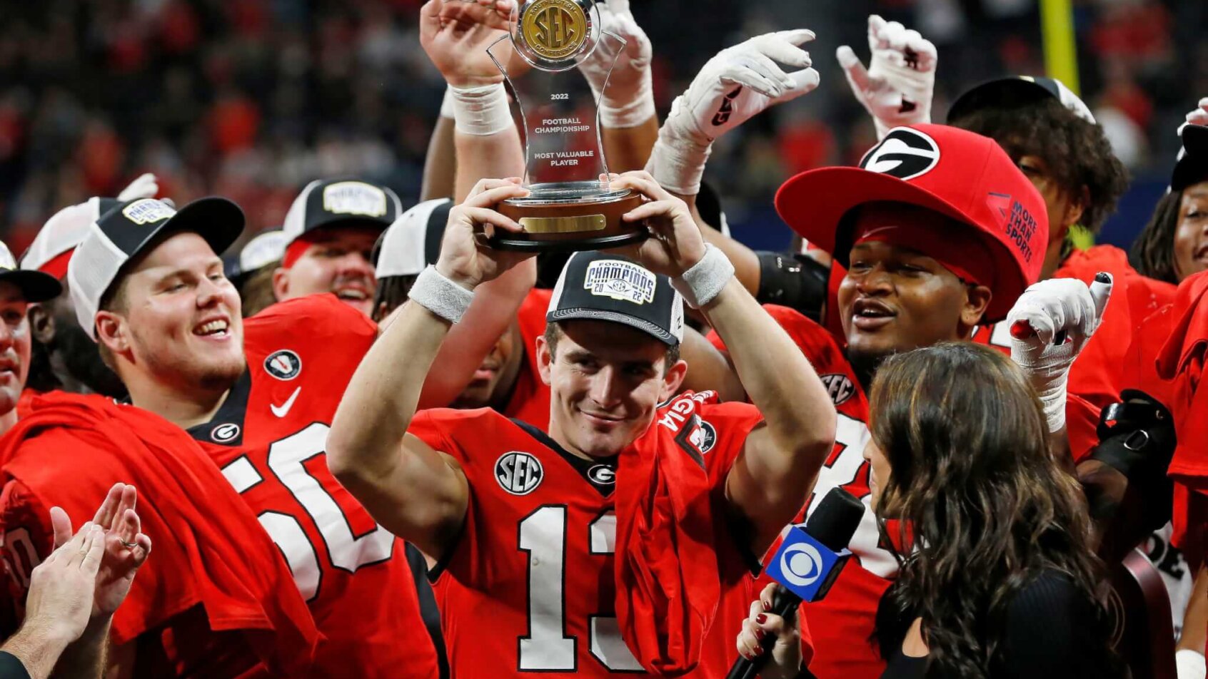 Georgia quarterback Stetson Bennett lifting the SEC Championship MVP award