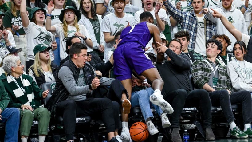 Northwestern's Chase Audige plows jumps into the crowd