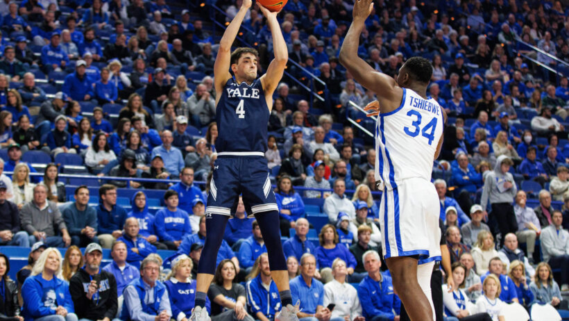 Yale Bulldogs guard John Poulakidas shooting a three